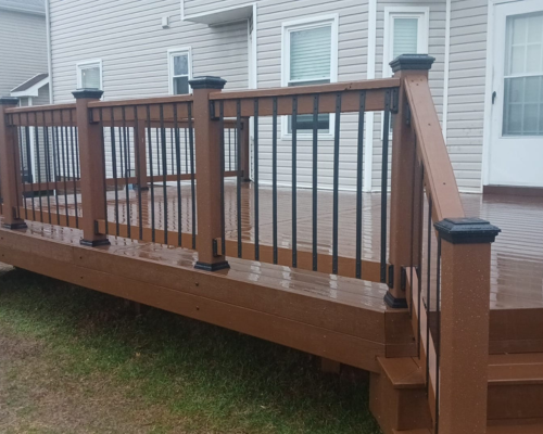 Stained composite deck with metal railing